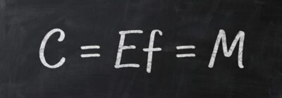 Eastwood's primary Internal Science equation written on a university blackboard,  "C=Ef=M™"